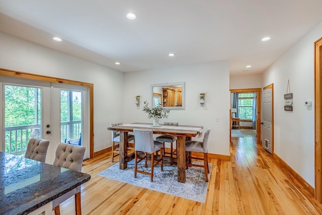 dining space with french doors, light wood-type flooring, baseboards, and recessed lighting