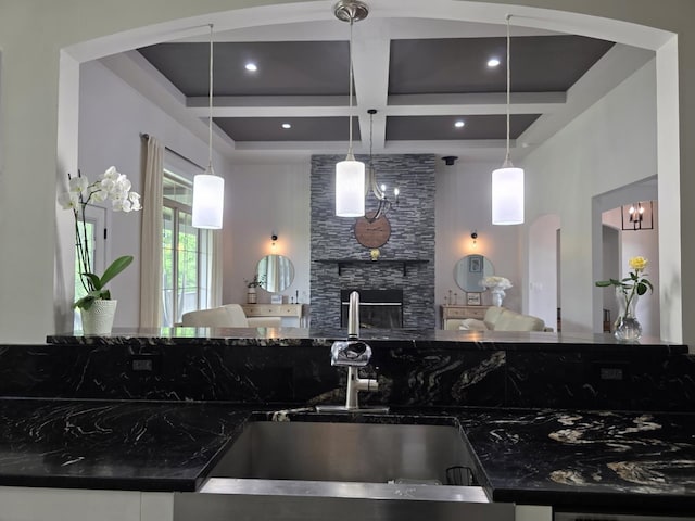473 Meadow Rd, Inman, SC 29349 - kitchen featuring a sink, coffered ceiling, dark stone counters, open floor plan, and a stone fireplace