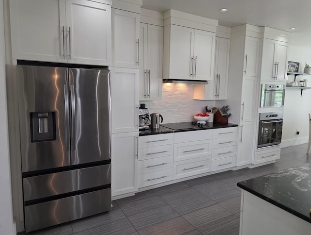 473 Meadow Rd, Inman, SC 29349 - kitchen featuring stainless steel fridge with ice dispenser, white cabinetry, backsplash, dark tile patterned floors, and recessed lighting