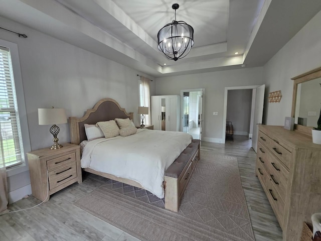 473 Meadow Rd, Inman, SC 29349 - bedroom featuring a chandelier, wood finished floors, a raised ceiling, and baseboards