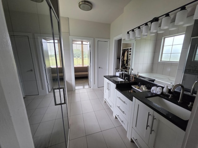 473 Meadow Rd, Inman, SC 29349 - bathroom with tile patterned flooring, a garden tub, vanity, a walk in closet, and a shower stall