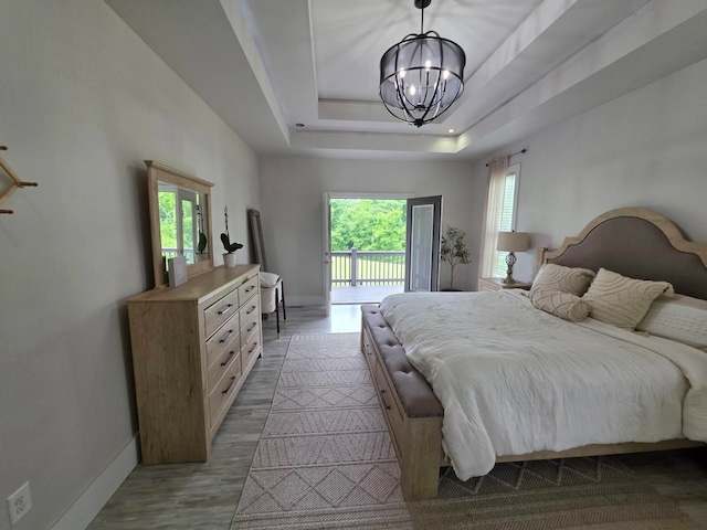 473 Meadow Rd, Inman, SC 29349 - bedroom with access to exterior, a chandelier, light wood-type flooring, baseboards, and a raised ceiling