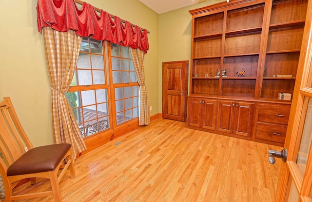 sitting room with light wood finished floors and baseboards