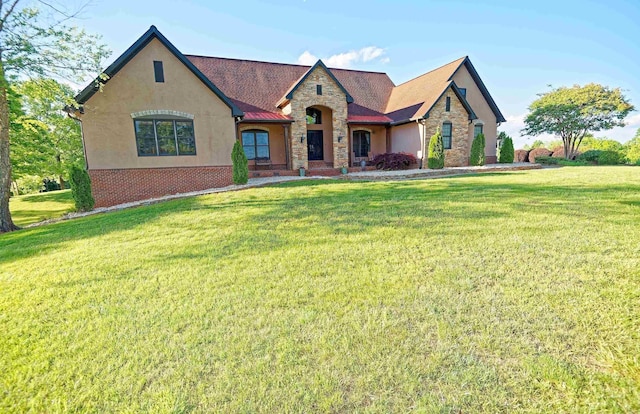 view of front facade with stone siding, a front yard, and stucco siding