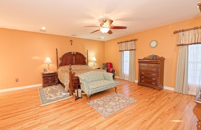 bedroom featuring wood finished floors, baseboards, and ceiling fan