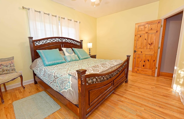 bedroom with light wood-type flooring and baseboards