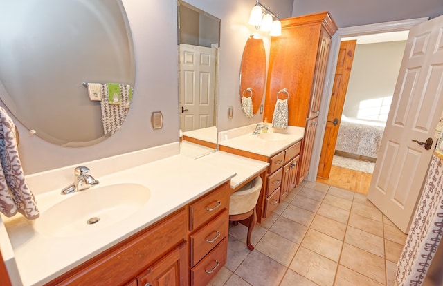 ensuite bathroom featuring two vanities and tile patterned floors