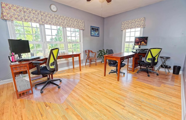 office space with wood finished floors, a ceiling fan, and baseboards
