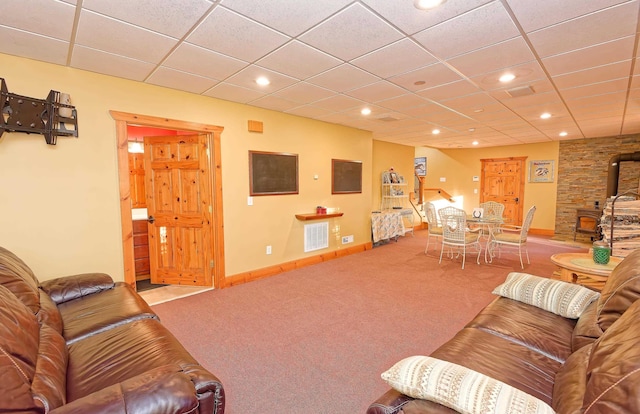 living area with a wood stove, carpet flooring, recessed lighting, and baseboards