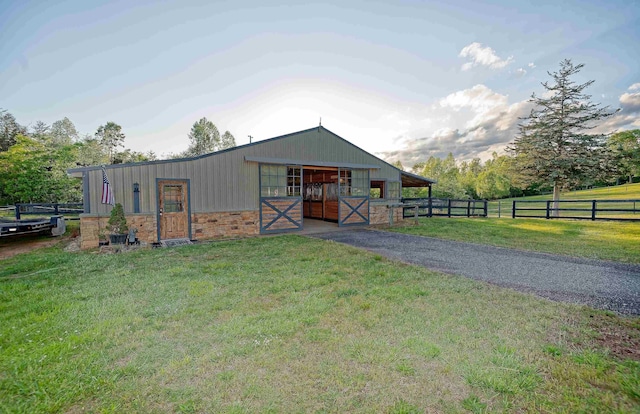 view of front of house with an exterior structure, an outbuilding, and stone siding