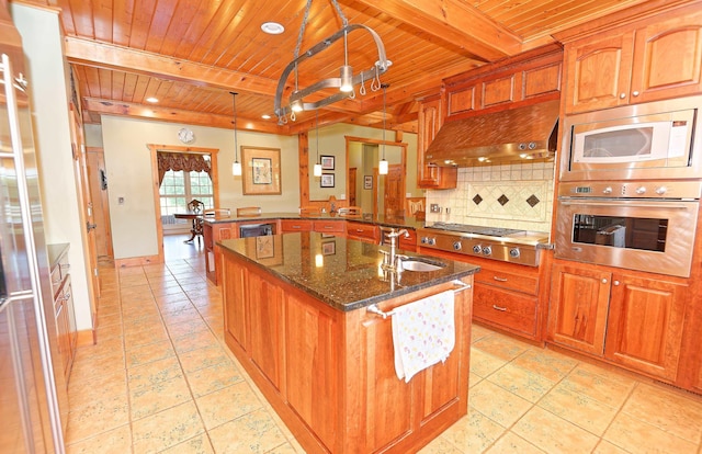 kitchen with appliances with stainless steel finishes, wooden ceiling, a sink, under cabinet range hood, and a peninsula