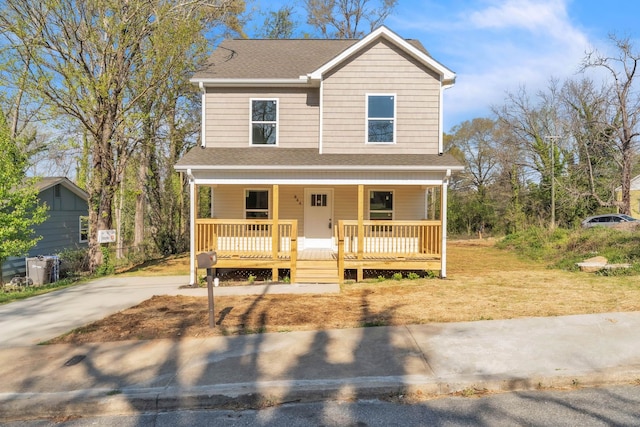 view of front facade featuring a porch, a shingled roof, and concrete driveway