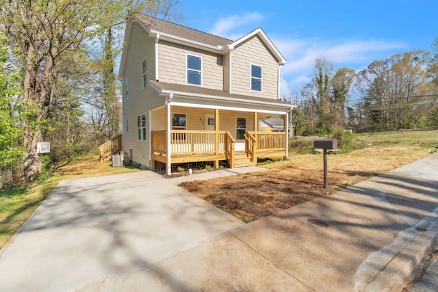 view of front facade featuring covered porch and central AC unit