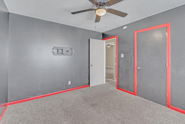 unfurnished bedroom featuring carpet flooring and a ceiling fan