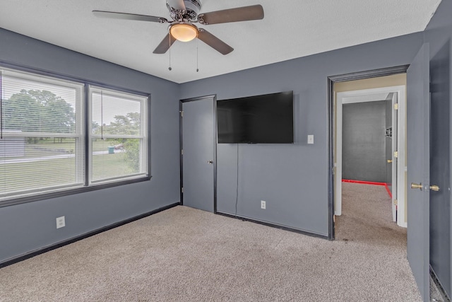 unfurnished bedroom with carpet floors, a closet, and baseboards