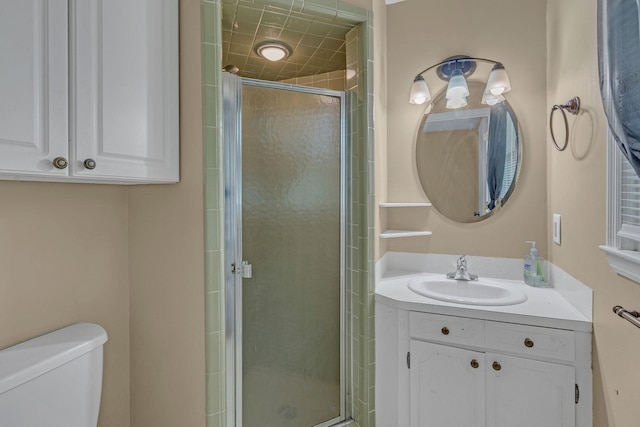 full bathroom featuring a stall shower, toilet, and vanity