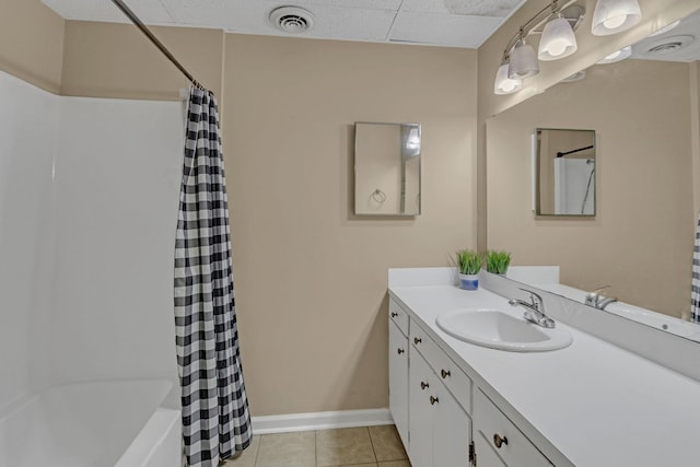 full bath featuring tile patterned floors, baseboards, vanity, shower / bath combination with curtain, and a paneled ceiling