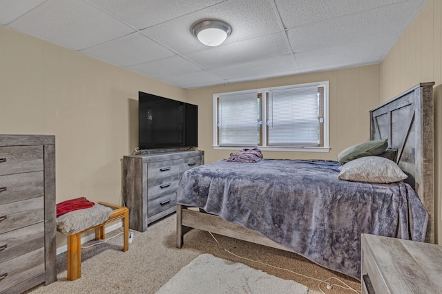 carpeted bedroom with a paneled ceiling