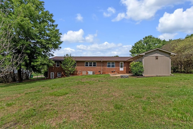 rear view of house with a yard and brick siding