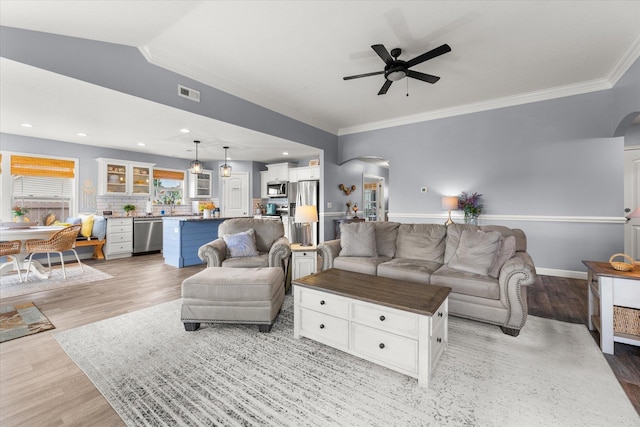 1101 Rosabella, Greer, SC 29651 - living area featuring arched walkways, ornamental molding, a ceiling fan, light wood-style flooring, and baseboards