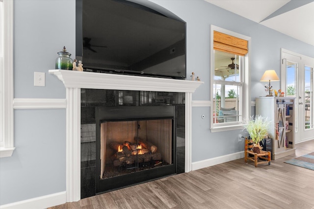 1101 Rosabella, Greer, SC 29651 - detailed view of a tiled fireplace, wood finished floors, a ceiling fan, and baseboards