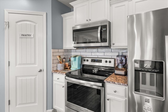 1101 Rosabella, Greer, SC 29651 - kitchen featuring appliances with stainless steel finishes, decorative backsplash, light stone counters, and white cabinets