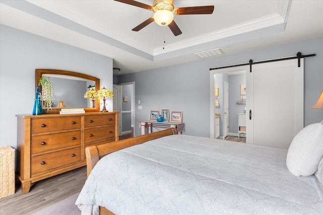 1101 Rosabella, Greer, SC 29651 - bedroom with a raised ceiling, a barn door, wood finished floors, ornamental molding, and ceiling fan