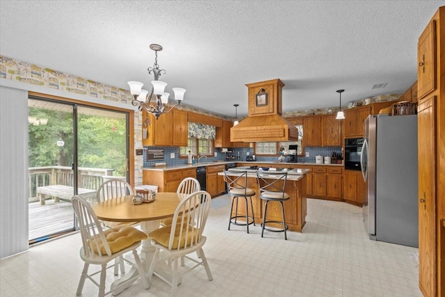 dining space featuring a chandelier, a textured ceiling, and light carpet