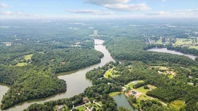 aerial view of a nearby body of water and a heavily wooded area