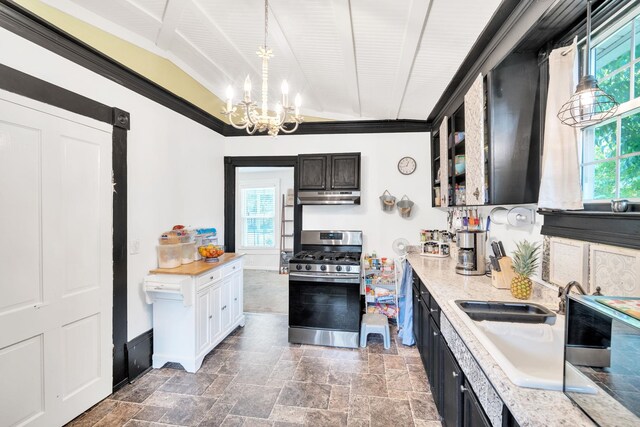114 Martin, Laurens, SC 29360 - kitchen with stainless steel gas range oven, under cabinet range hood, a chandelier, stone finish flooring, and pendant lighting