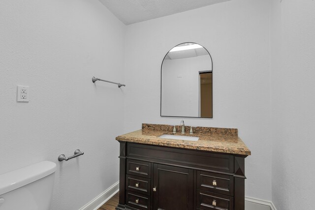 10 Beech, Spartanburg, SC 29303 - bathroom with vanity, toilet, baseboards, and wood finished floors