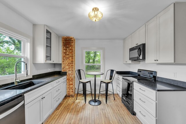 10 Beech, Spartanburg, SC 29303 - kitchen with black appliances, a sink, dark countertops, white cabinets, and glass insert cabinets