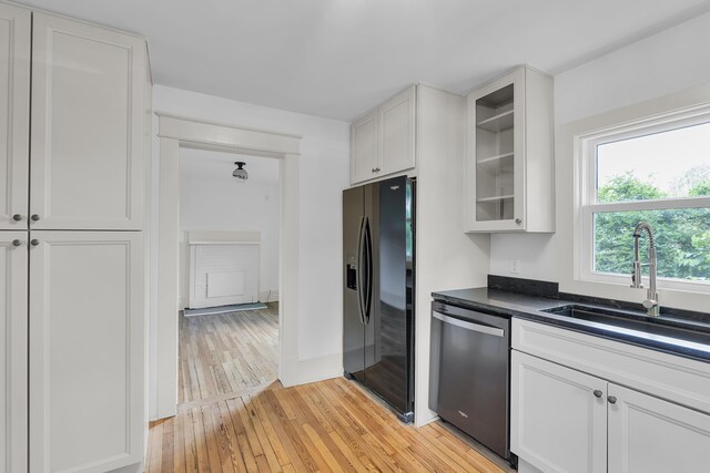 10 Beech, Spartanburg, SC 29303 - kitchen featuring stainless steel dishwasher, black fridge with ice dispenser, a sink, light wood-type flooring, and glass insert cabinets