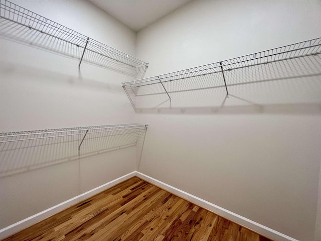 spacious closet with wood finished floors