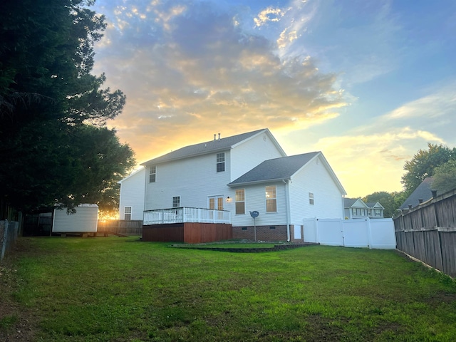 rear view of house featuring crawl space, a shed, a deck, and an outdoor structure