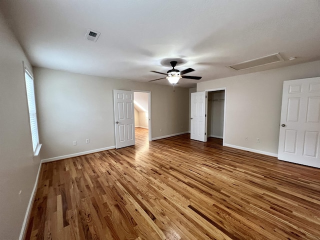 unfurnished bedroom featuring wood finished floors, baseboards, and ceiling fan