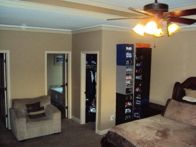 108 Dewfield, Boiling Springs, SC 29316 - bedroom featuring crown molding, baseboards, carpet, a walk in closet, and a closet