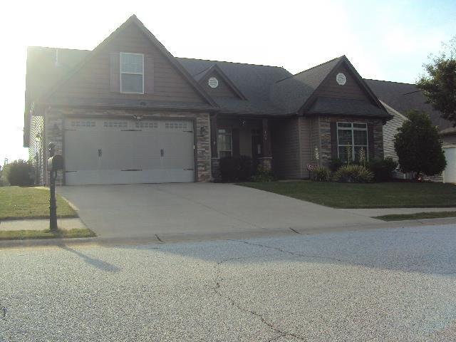 108 Dewfield, Boiling Springs, SC 29316 - view of front of house with concrete driveway, stone siding, and a garage