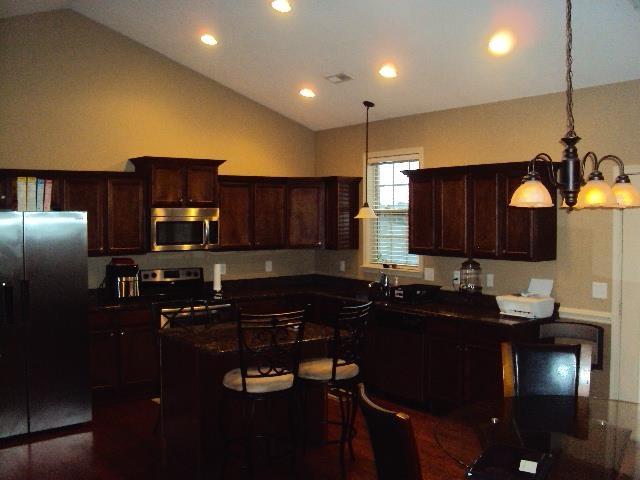 108 Dewfield, Boiling Springs, SC 29316 - kitchen with appliances with stainless steel finishes, lofted ceiling, dark countertops, a chandelier, and recessed lighting