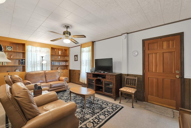 1 Robinsview, Spartanburg, SC 29301 - carpeted living area featuring wood walls, built in shelves, ceiling fan, and a wainscoted wall