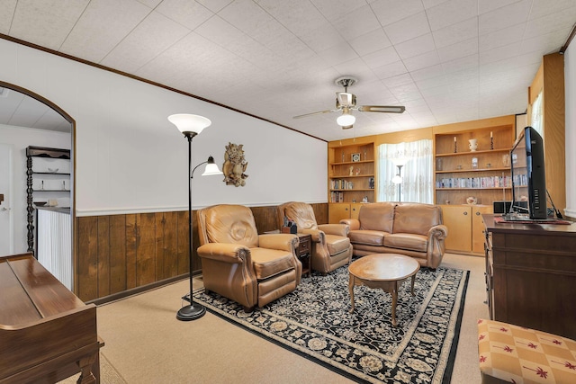 1 Robinsview, Spartanburg, SC 29301 - carpeted living room with crown molding, ceiling fan, built in shelves, wainscoting, and wood walls
