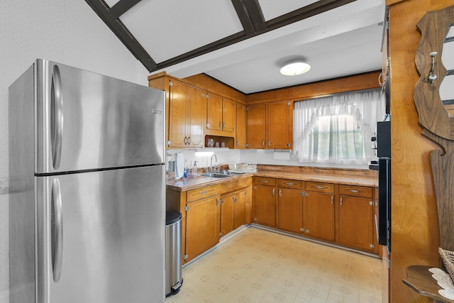 1 Robinsview, Spartanburg, SC 29301 - kitchen with freestanding refrigerator, brown cabinetry, light countertops, a sink, and light flooring