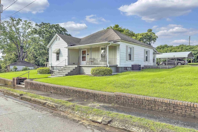 1 Robinsview, Spartanburg, SC 29301 - view of front facade featuring covered porch, a detached carport, central air condition unit, a front lawn, and a shingled roof