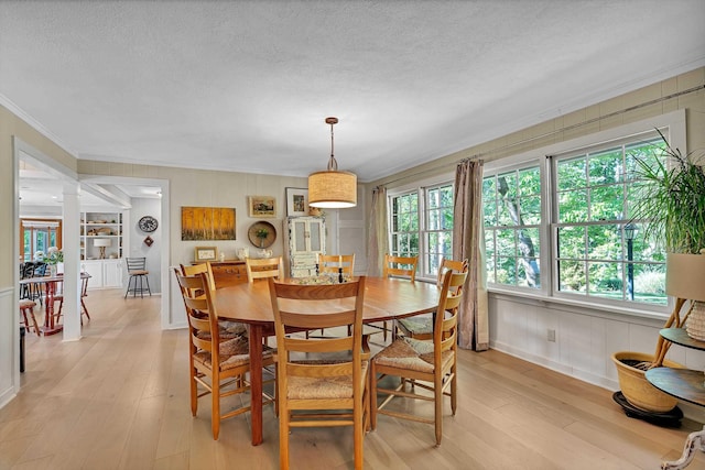 7 Hearthstone, Landrum, SC 29356 - dining area with crown molding, light wood-style floors, a textured ceiling, and baseboards
