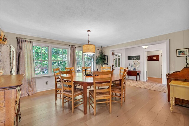 7 Hearthstone, Landrum, SC 29356 - dining room with light wood-style flooring, a textured ceiling, and crown molding