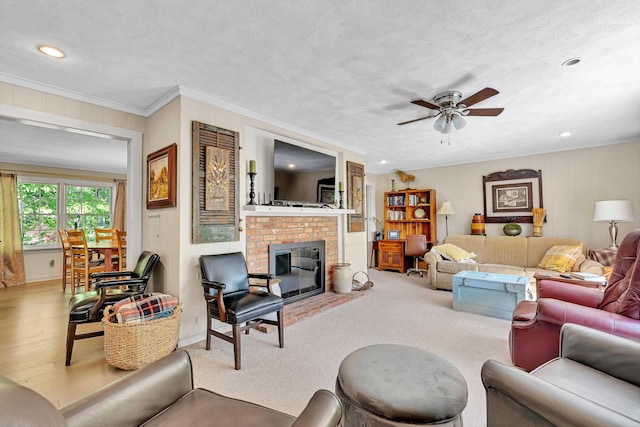 7 Hearthstone, Landrum, SC 29356 - living area featuring a ceiling fan, a textured ceiling, a fireplace, recessed lighting, and crown molding