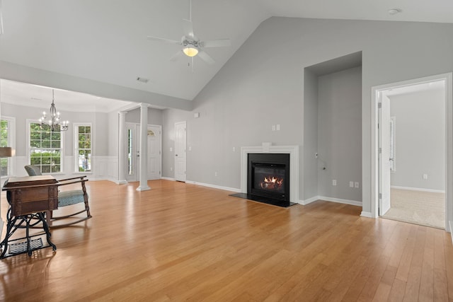 616 W Farrell, Woodruff, SC 29388 - living room with light wood finished floors, ceiling fan, a glass covered fireplace, high vaulted ceiling, and ornate columns