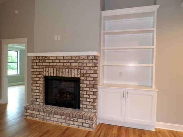 291 Robbins, Chesnee, SC 29323 - detailed view of wood finished floors, a brick fireplace, and baseboards