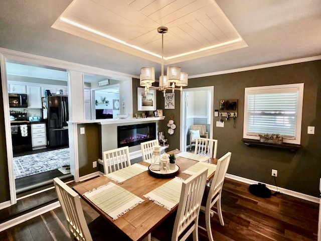 719 Magness Dr, Spartanburg, SC 29303 - dining space with a raised ceiling, dark wood finished floors, baseboards, a chandelier, and crown molding