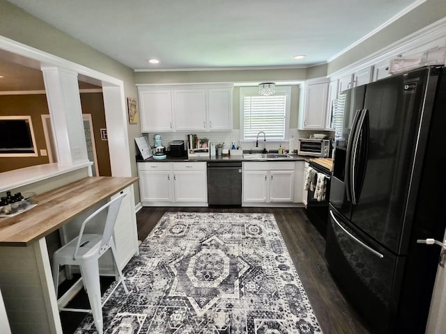 719 Magness Dr, Spartanburg, SC 29303 - kitchen with black appliances, a sink, white cabinets, dark wood-type flooring, and ornamental molding